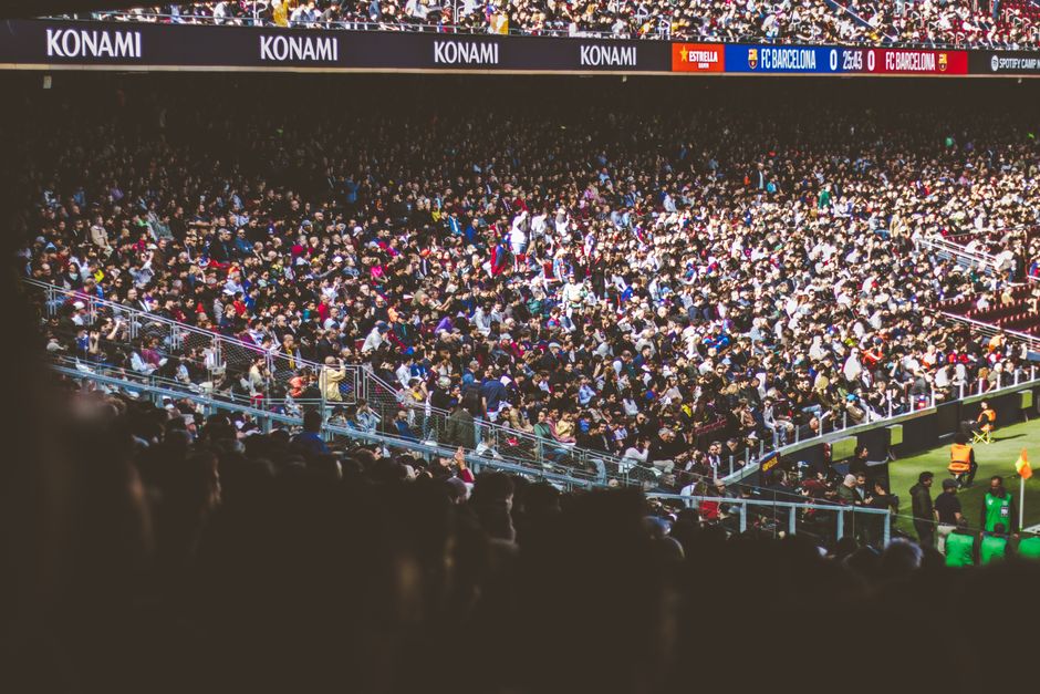 A vibrant crowd fills a football stadium during a lively match.