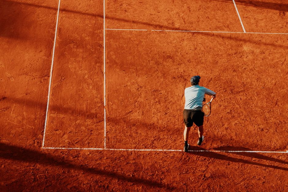 Aerial view of a tennis player serving on a clay court. Shot in Buenos Aires, Argentina.