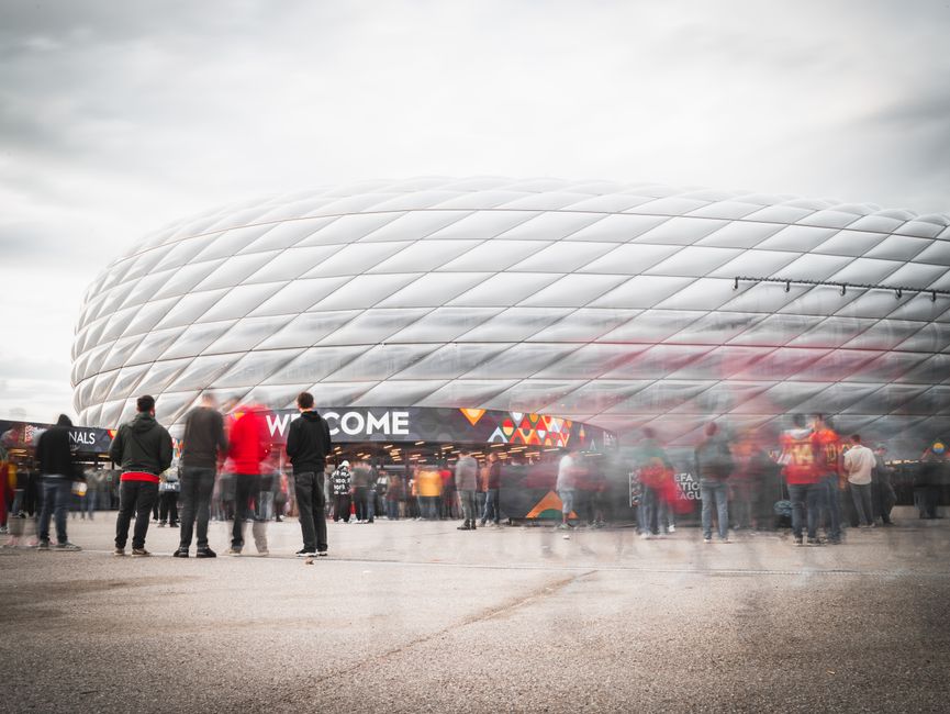Fans gathering outside Allianz Arena in Munich, Germany, ready for a soccer event.